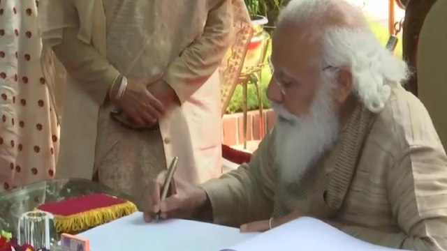 PM Modi signs visitors book at Bangabandhu Mausoleum Complex