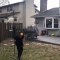 Kid Stands In Frontyard And Throws Ball Inside Window Basketball Hoop