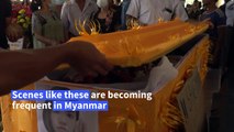 Bereaved raise three-finger final salute at Myanmar funerals