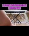 playing the piano  while lying in bed