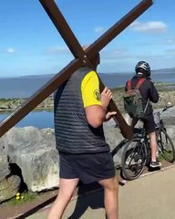 Boxing champion Tyson Fury carries a cross along Morecambe promenade on Good Friday