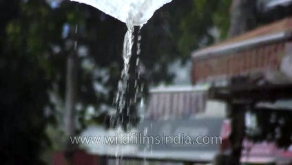 People protect themselves under the umbrella in a rainy day