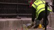 Workers remove flowers from outside Buckingham Palace