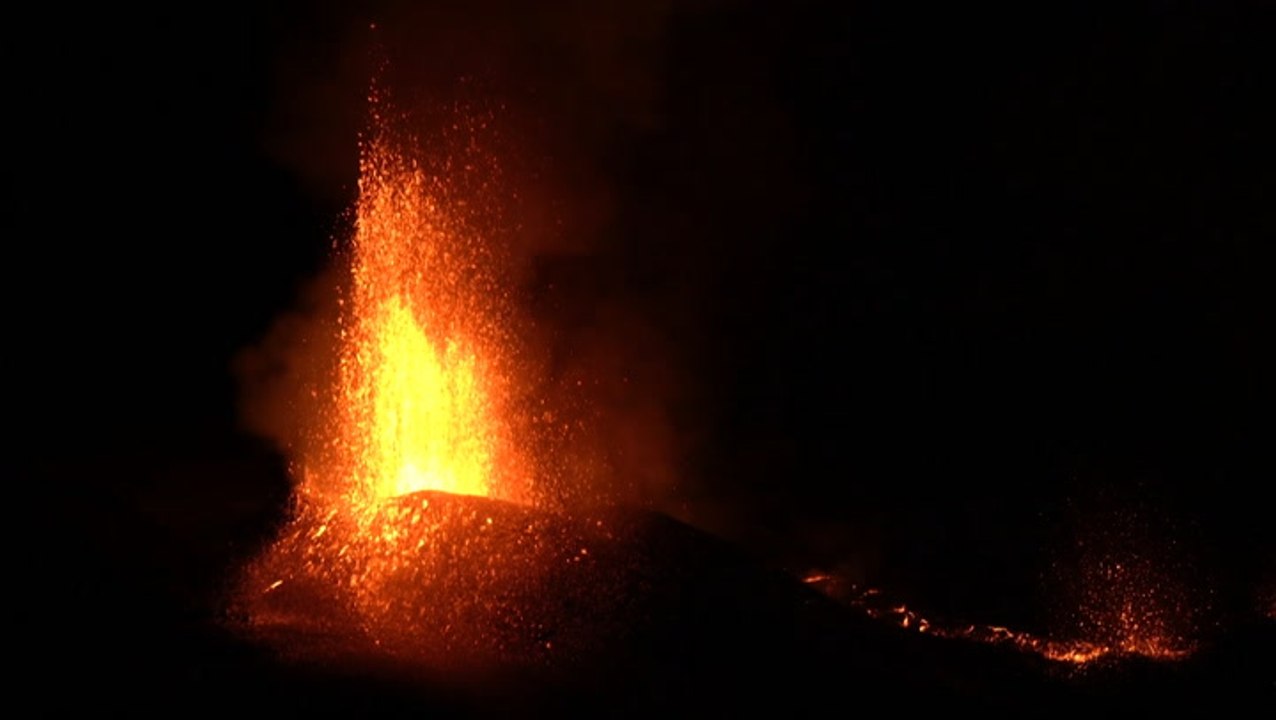 Hikers watch as volcano erupts