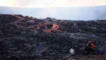 Guests watch as lava pours from volcano
