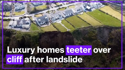 Luxury homes left teetering over cliff after Wales beach landslide