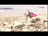عناصر حزب الله يرفعون العلم اللبناني وراية الحزب في جرود عرسال