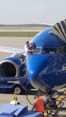 Airline Pilots Manually Wipe Windshield before Flight