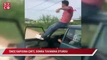 Otomobilin önce kapısına çıktı, sonra tavanına oturdu