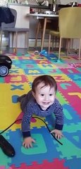 Adorable baby boy think the remote control is histerical
