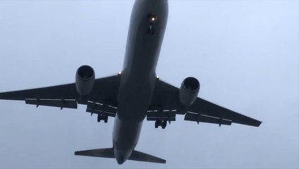 Plane emerges from low clouds on approach to New York