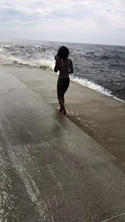 Lady Posing for Picture Surprised by Big Wave