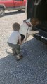 Boy Boosts Basset Hound into Truck