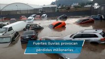 Depósito de autos de lujo se inunda tras lluvias en Edomex