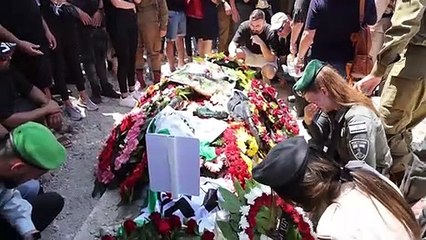 Palestinians and Israelis bury their dead after constant exchange of rocket fire and air strikes