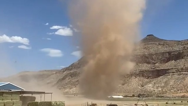 Dust devil towers over Utah farm amid dry heat