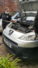 Scottish SPCA staff try to coax an otter out from under a car at an address on Wardie Avenue in Edinburgh.