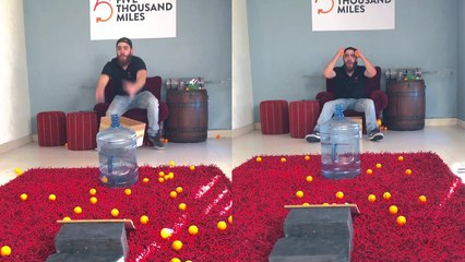 'Trickshot artist shows how to spit a ping pong ball into a water jug'