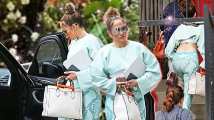 JLo looked busy showing off her full bust in a mint green crop top over a white sports bra