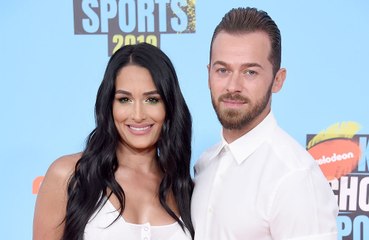 Why are Nikki Bella and Artem Chigvintsev considering delaying their wedding?