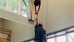 Woman Balances Herself on Man's Head and Arm One by One While Performing Handstand