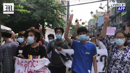 Dozens march briskly through Yangon in flash Myanmar protest
