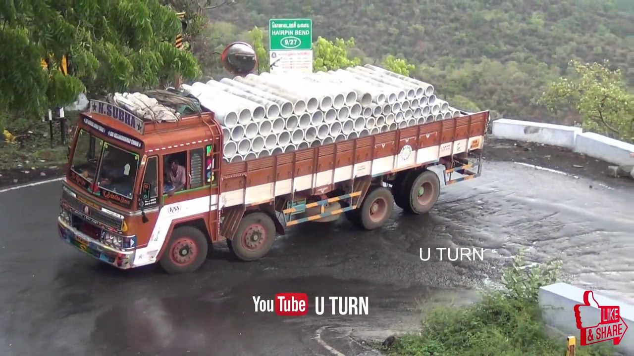 Truck With Full Load of Cement Pipes On Narrow Bend