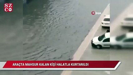 Yağmur sonrası araçta mahsur kalan vatandaşı, halat yardımıyla yüzerek kurtardı...