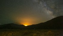 Wildfire lights up the Utah night sky as the Milky Way passes overhead