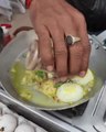 Person Stir-Fries Hard-Boiled Egg With Spices