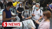 Snaking queues at Hong Kong news stands as Apple Daily rolls out last edition