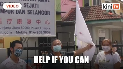 Kepong MP Lim Lip Eng  gives donation to rehabilitation centre with flying white flag