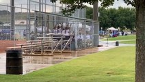 Competing softball teams join forces for rain delay singalong