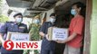 Families in Kuching receive food baskets from cops