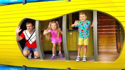 Diana and Roma play with Dad at the playground