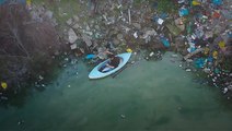 Paddling Along The Trash-Filled Dam