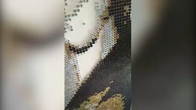 Darren Timby screws in the last screw of his Elvis Presley artwork