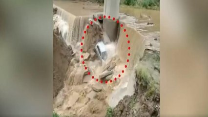 Swept away in gushing water, car stuck in bridge's pillar