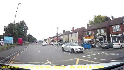 Oncoming Car Tipped to Two Wheels in Traffic