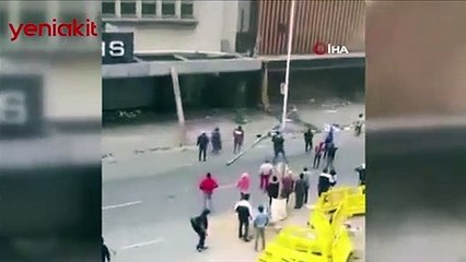 Ülke savaş alanına döndü! Yağmacıların ateşe verdiği binadan bebeğini atarak kurtardı