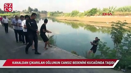 Kanaldan çıkarılan oğlunun cansız bedenini kucağında taşıdı