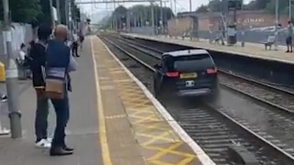 Cheshunt: Moment 'stolen car' speeds off down train tracks