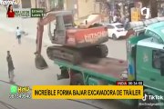 Conductor muestra su destreza al bajar excavadora de camión sin rampa