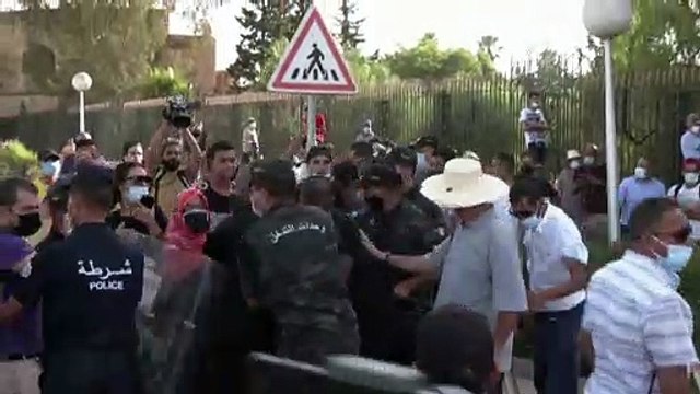 Opposing Tunisians gather outside parliament after government ouster