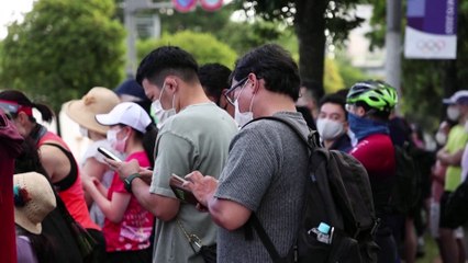 Officials urge spectators to heed calls to stay at home after they gather along triathalon route