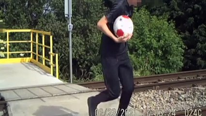 Shocking video shows young boys dicing with death as they play football and dance on a busy railway crossing