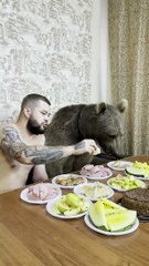 Bear Enjoying a Snack With His Human Best Friend