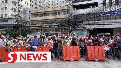 Chaos and confusion at vaccination sites as thousands in the Philippines rush to get shots
