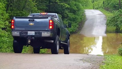 Mike driving through the water on the river road. Flood