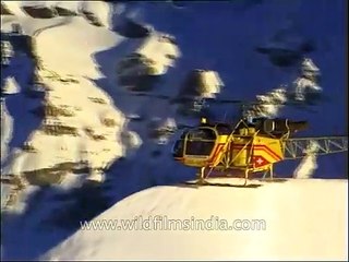 Swiss helicopter lands on a snowy Himalayan mountain-top